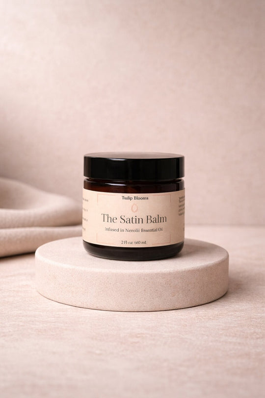 Satin Balm jar sitting on gold pedastool