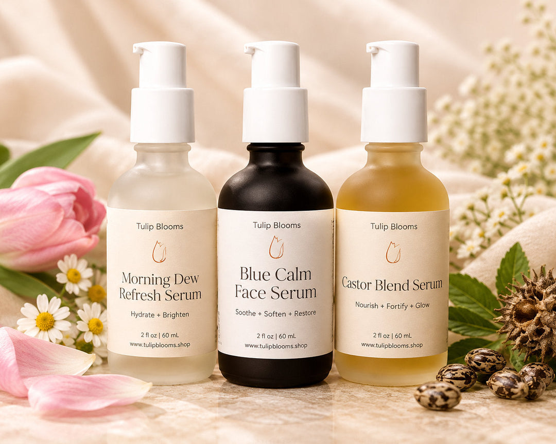 Tulip Blooms Youthful Serum Set featuring Morning Dew, Blue Calm Face Serum, and Castor Blend in glass pump bottles.