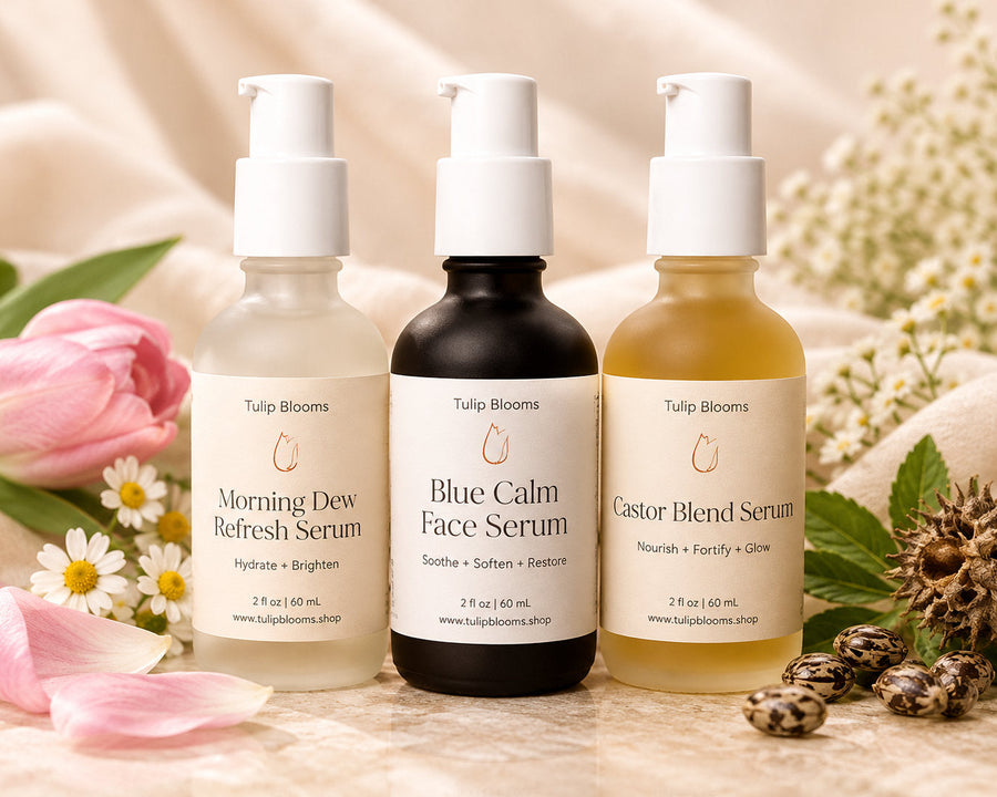 Tulip Blooms Youthful Serum Set featuring Morning Dew, Blue Calm Face Serum, and Castor Blend in glass pump bottles.
